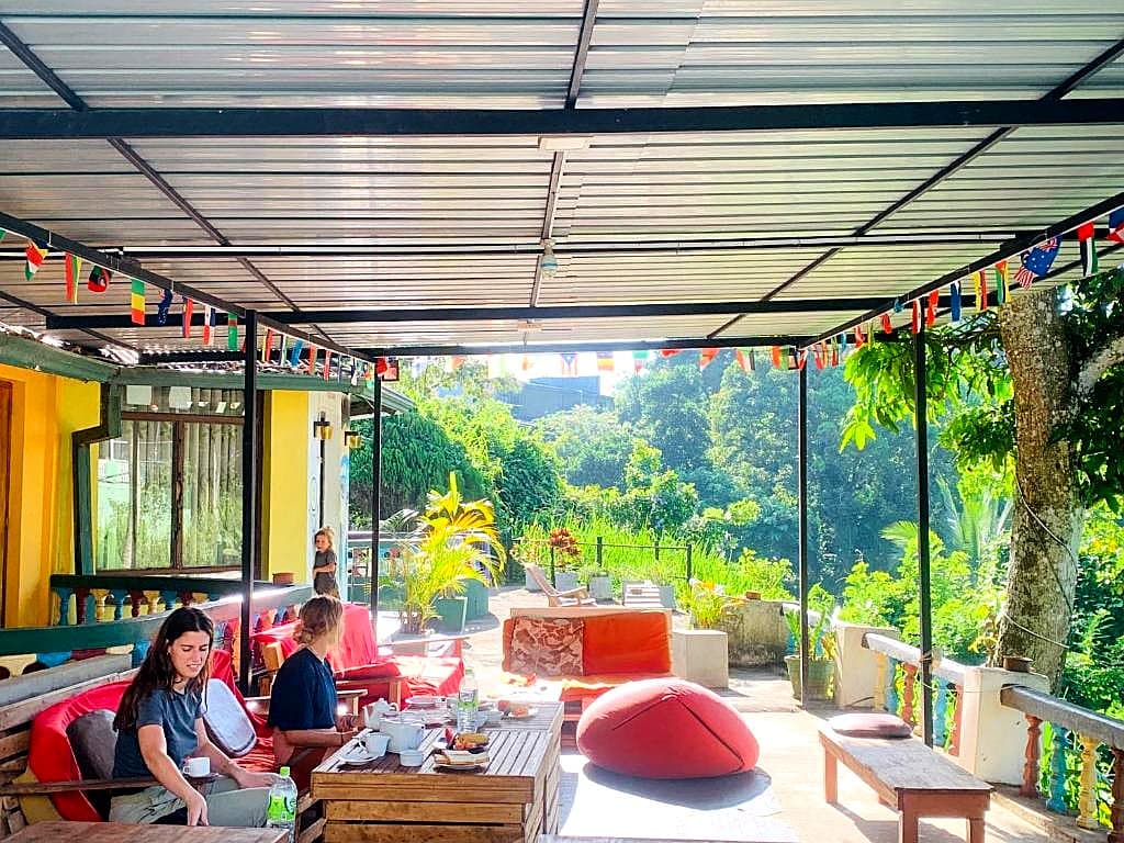 Terrace breakfast area strung with flags from every guest's home country