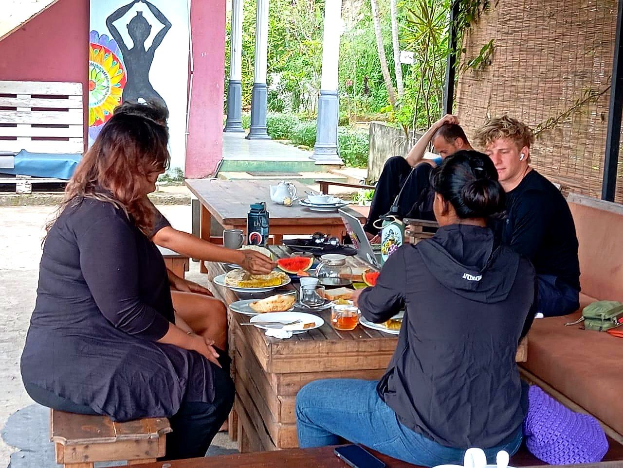 Guests sharing a home-cooked meal on the terrace